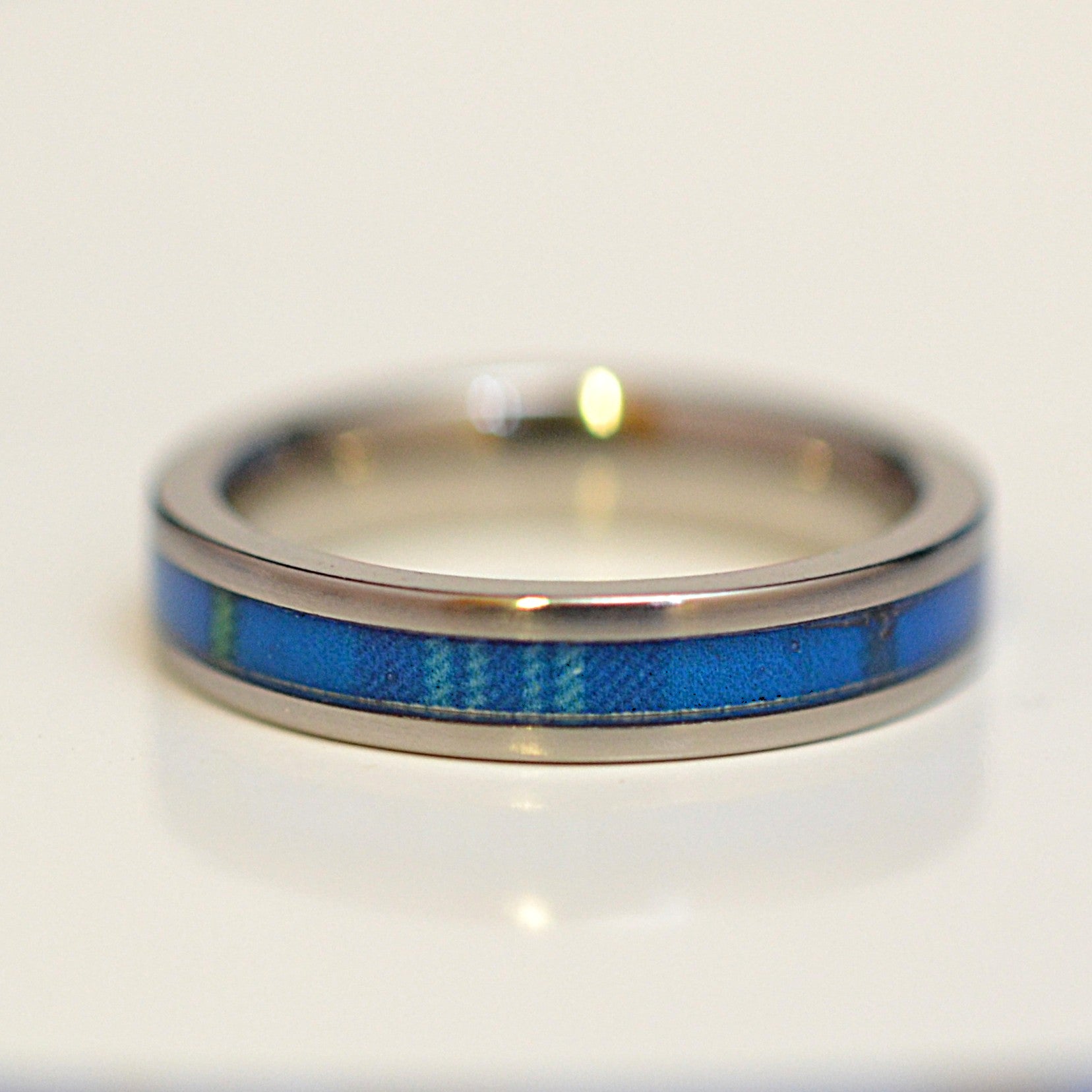 Front view of handcrafted stainless steel ring featuring The Citadel tartan inlay
