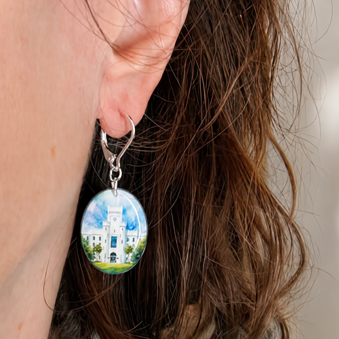 Double-sided Padgett-Thomas Barracks Citadel earrings handmade by Nancy Davis Studio, on a model