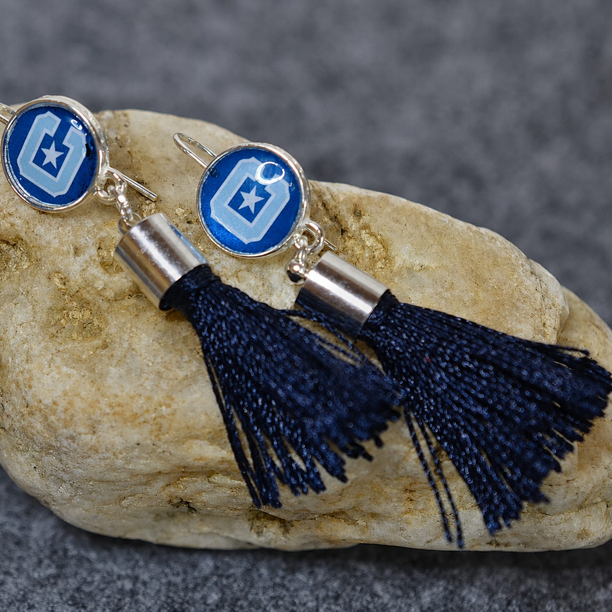 Block C and Star Citadel earrings with dark blue tassels and caps