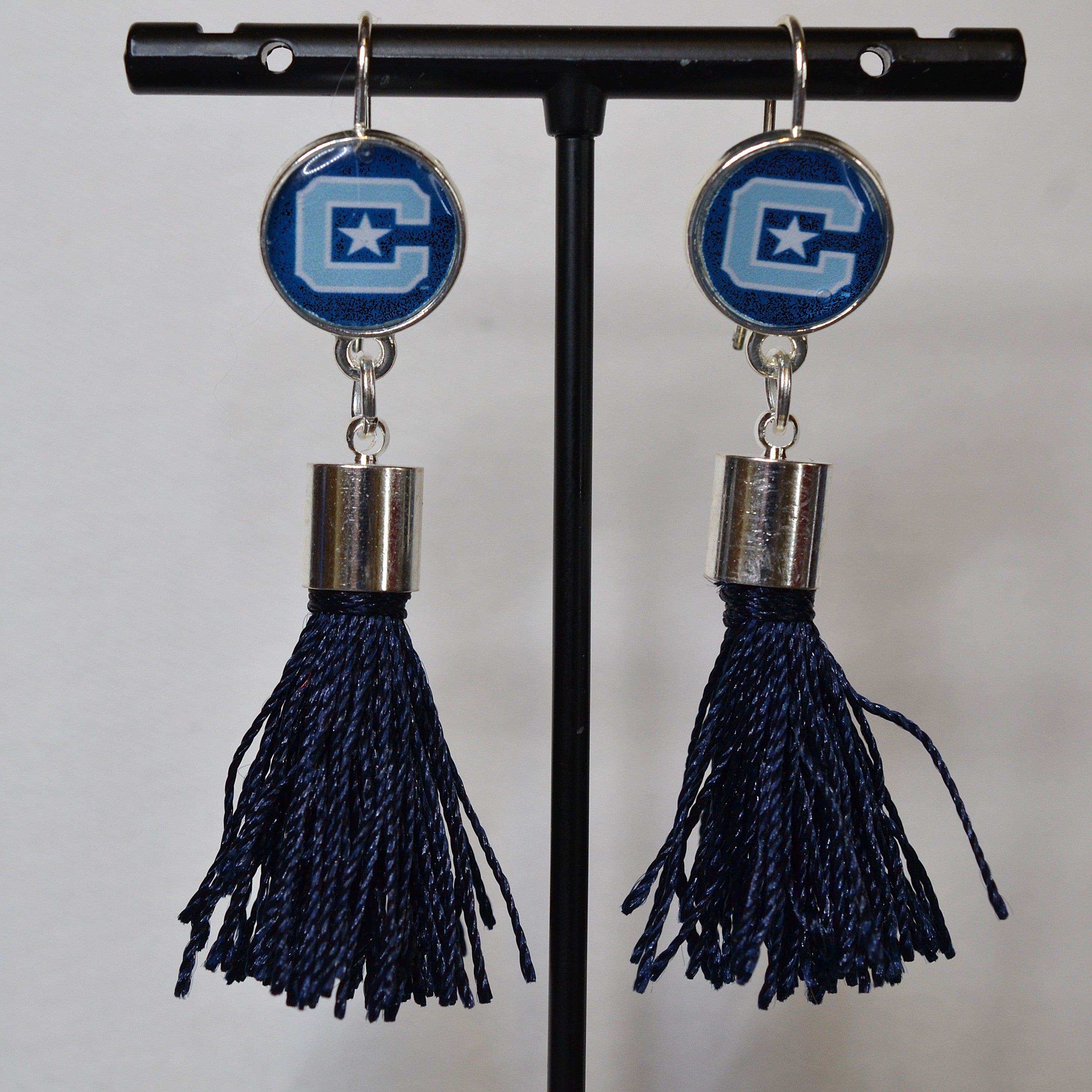 Block C and Star Citadel earrings with dark blue tassels and silver-tone caps