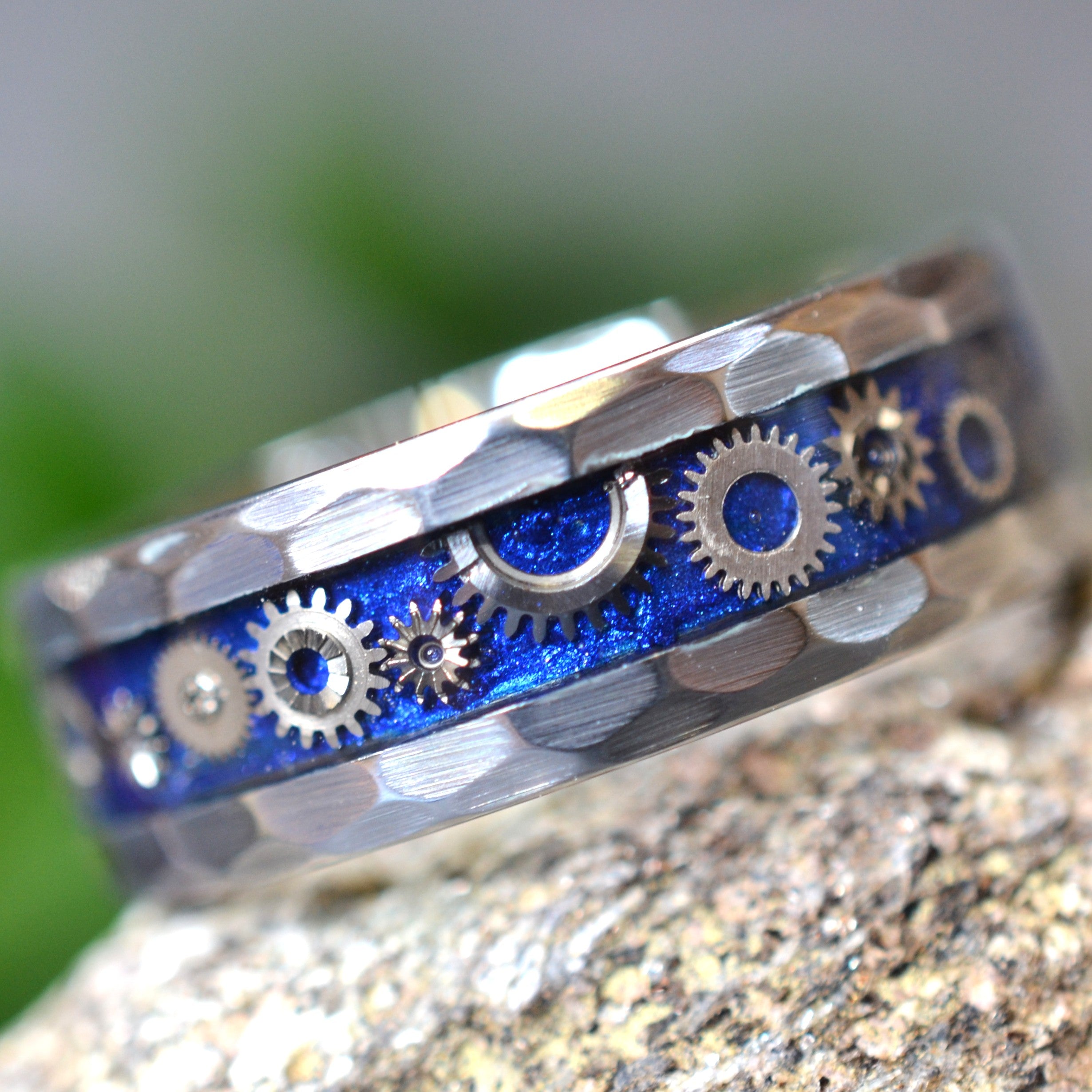 Timekeeper handmade faceted tungsten ring featuring genuine vintage watch gears set by hand in a sapphire-blue inlay beneath a crystal-clear finish.