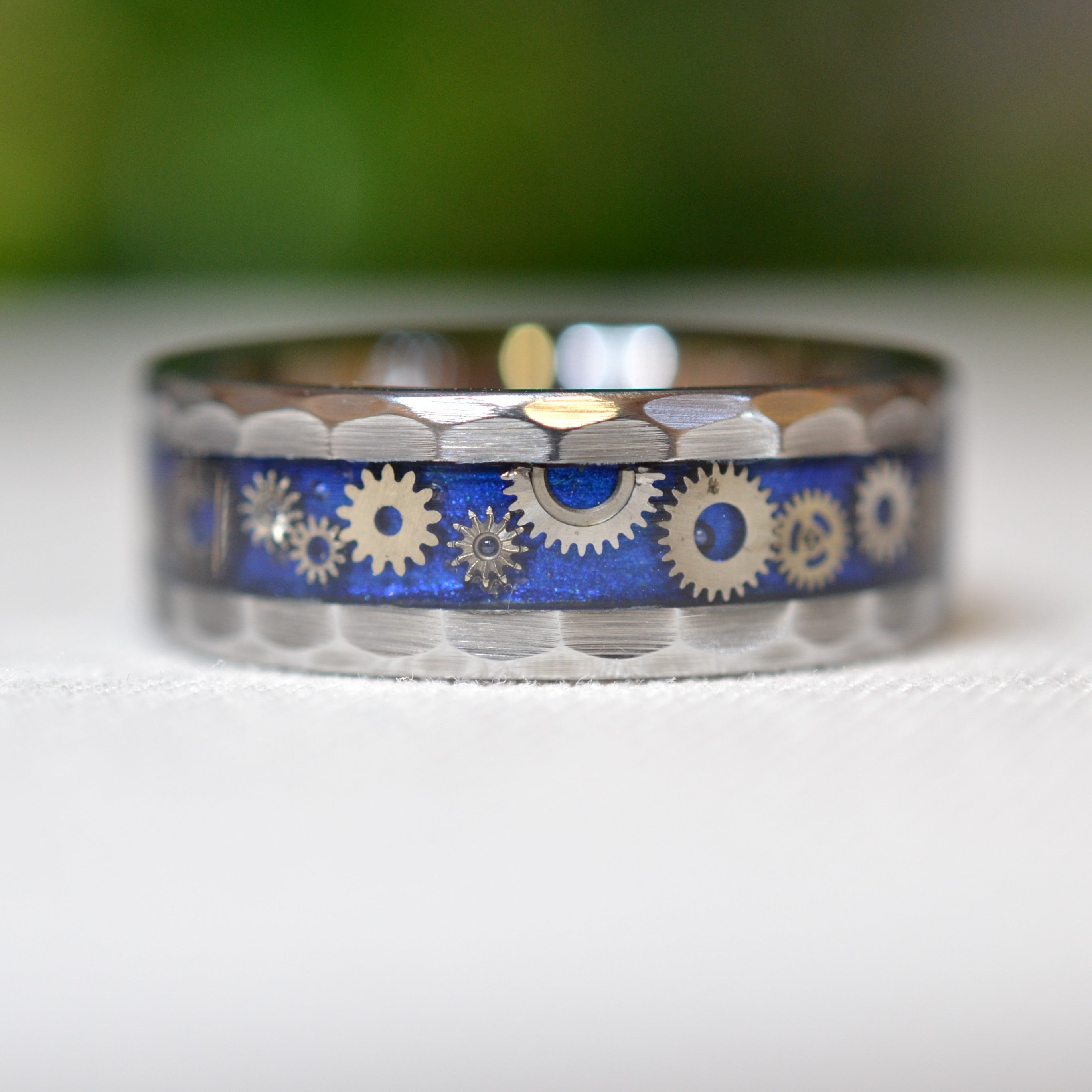 Front view of the Timekeeper tungsten ring highlighting genuine miniature watch gears preserved beneath a crystal-clear finish.