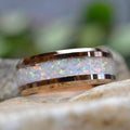 Handmade 8 mm rose gold tungsten opal ring featuring brilliant crushed white opal beneath a crystal-clear finish.