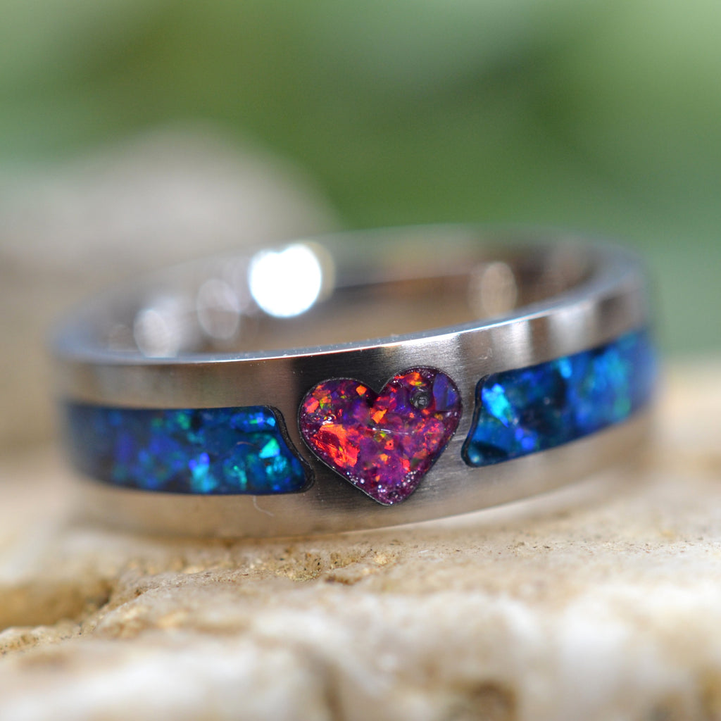 Handmade titanium heart ring featuring a pink crushed opal heart and blue crushed opal inlay in a comfort-fit band.