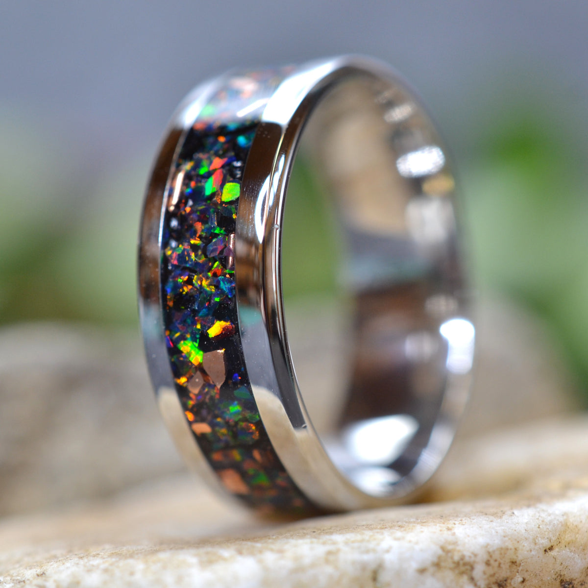 Side view of the Midnight Forge stainless steel black opal ring with genuine copper fragments and crushed black fire opal.