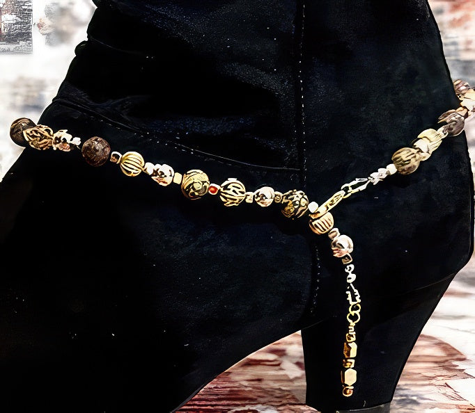 Gold filagree beaded chain on a boot