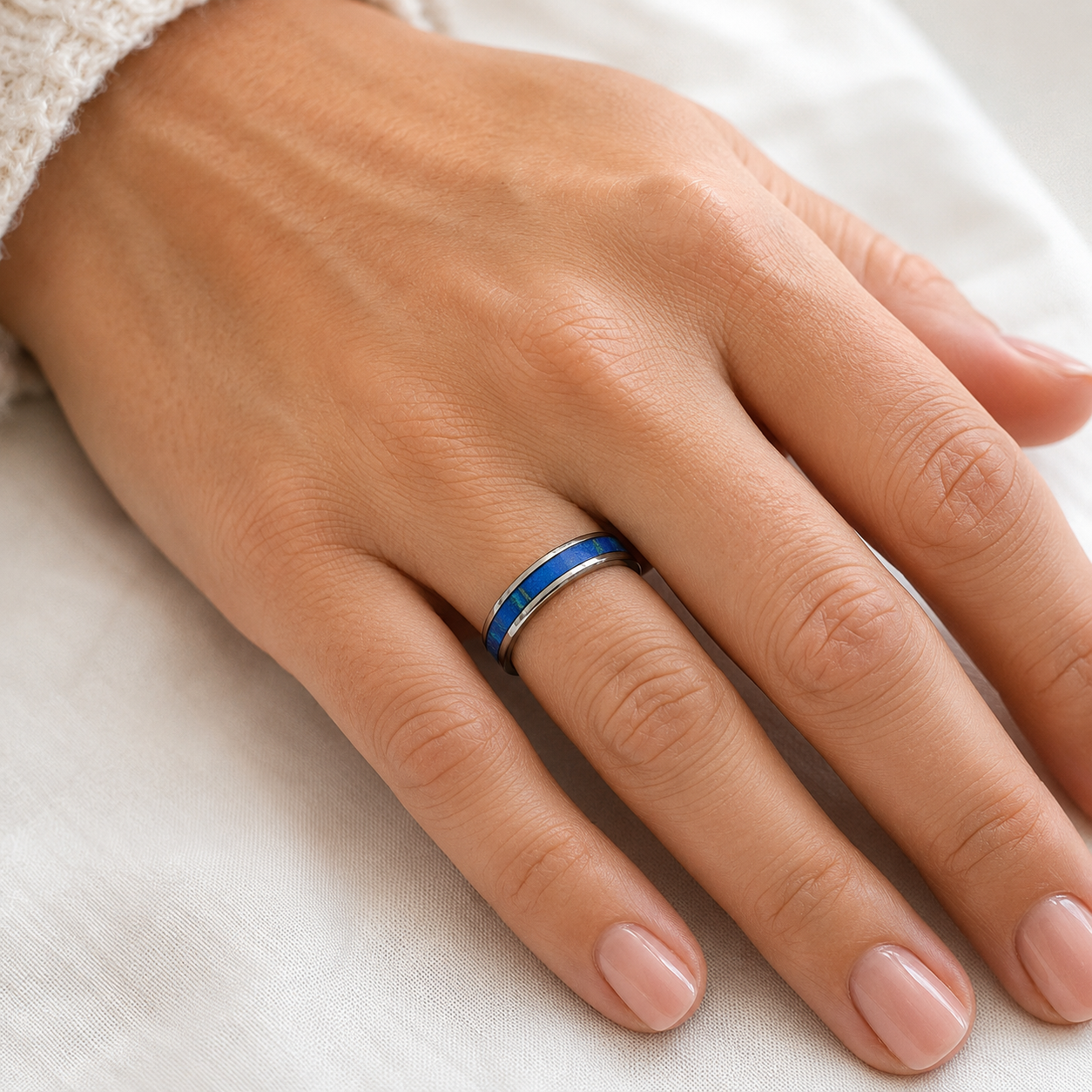 Woman wearing a slim stainless steel ring with The Citadel tartan inlay