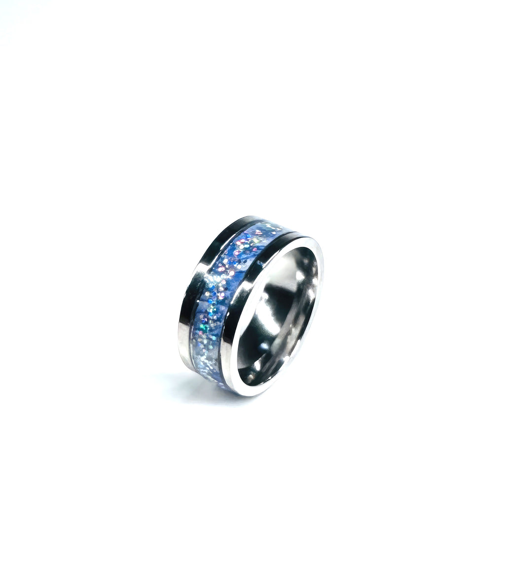 Tiny baby blue and silver flakes set into a gleaming silver band ring will make you feel like a million bucks