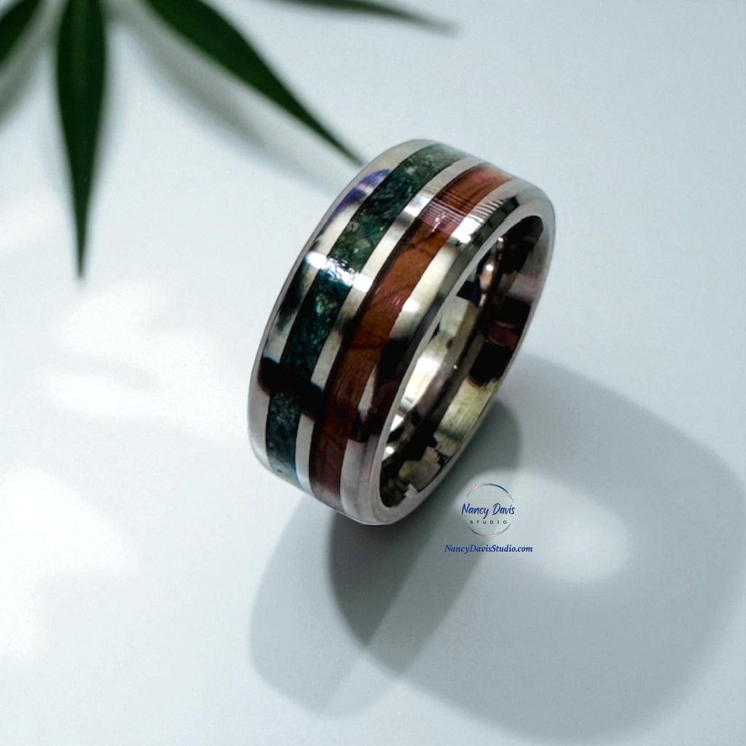 Zoisite and wood inlay in a double channel silver band ring